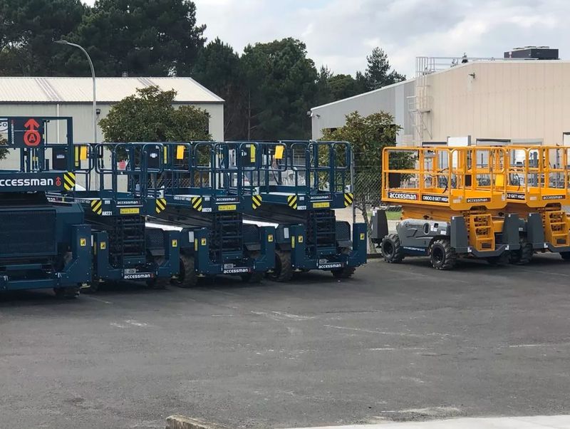 Accessman Waikato's yard with a fleet of boom lifts and scissor lifts