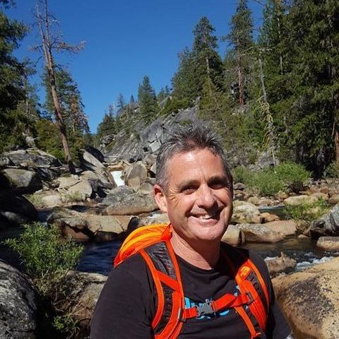 Paul Parker, Director of Com4, smiling outdoors on a trail run